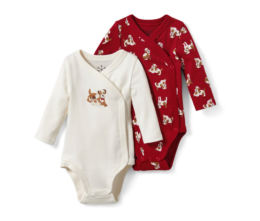 Dwa body niemowlęce: jedno kremowe z motywem psów, drugie czerwone z nadrukiem psów.