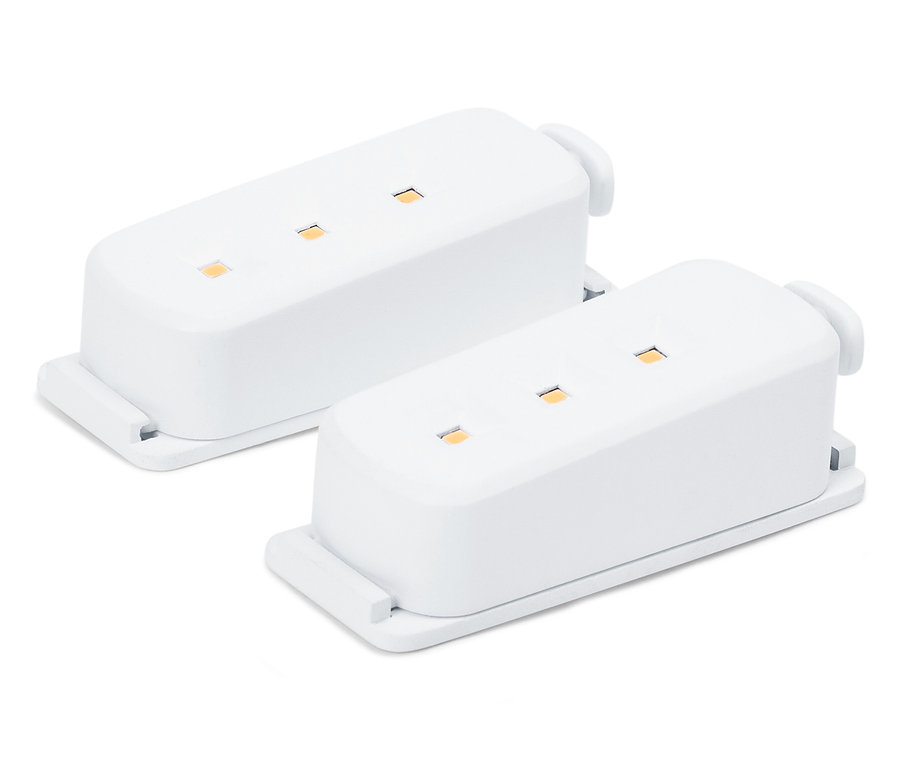 Dwa białe moduły elektroniczne z diodami LED na białym tle.