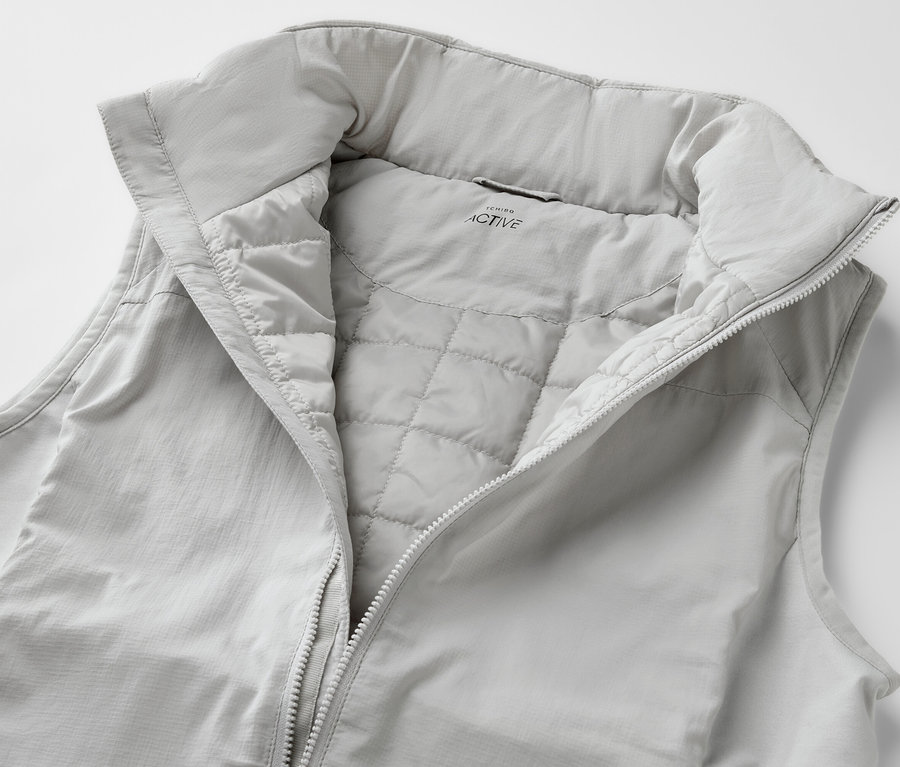 Jasnoszara kamizelka hybrydowa „pack light” z rozpiętym zamkiem błyskawicznym.