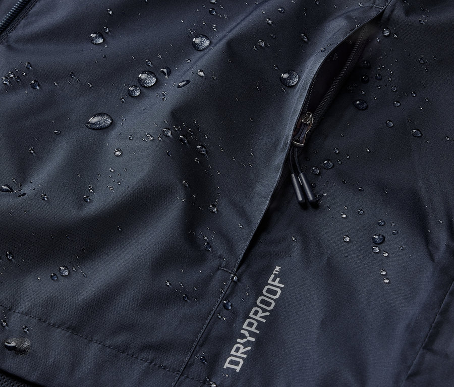 Zbliżenie granatowej kurtki przeciwdeszczowej z kieszenią na zamek i napisem DRYPROOF.