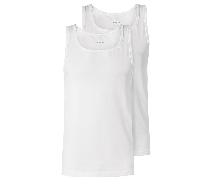 Dwa białe podkoszulki leżą na sobie.