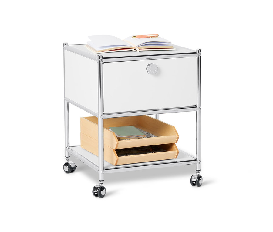 Biały metalowy stolik »CN3« z szufladą i kółkami. Na stoliku leży otwarta książka.