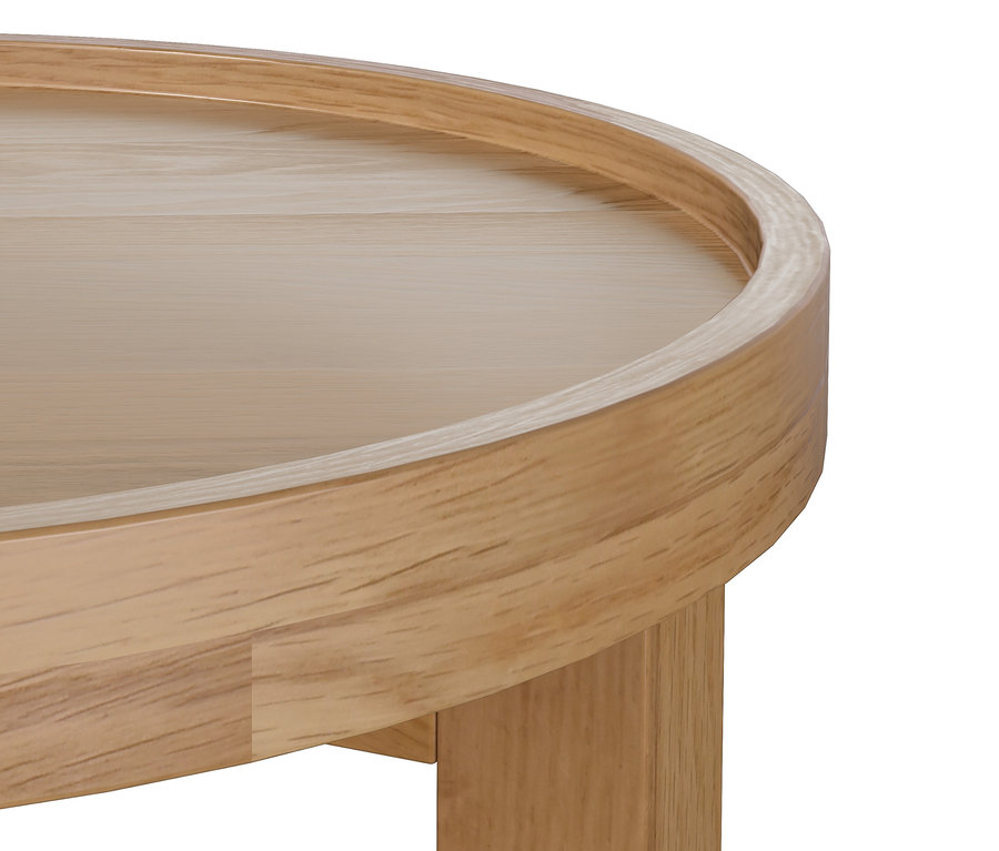 Fragment okrągłego stolika bocznego z jasnego drewna.