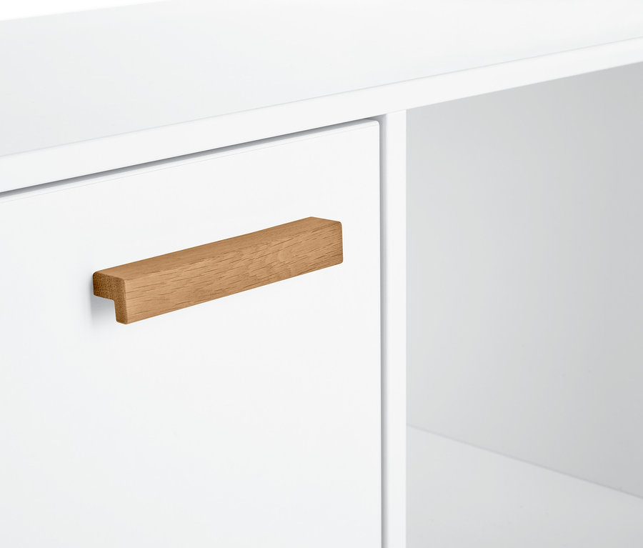 Detal białego kredensu z drewnianym uchwytem.