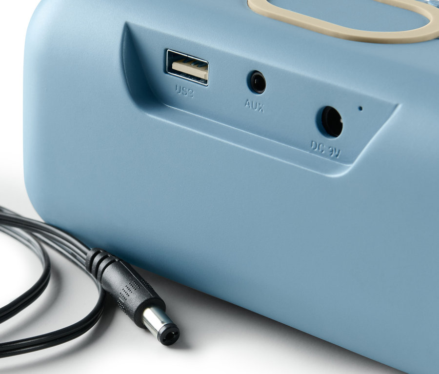 Szczegółowy widok niebieskiego głośnika z funkcją ładowania Qi i kablem.