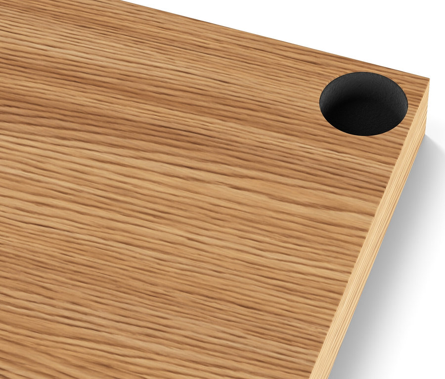 Fragment drewnianego blatu wąskiej metalowej komody „CN3” z czarnym otworem w rogu.