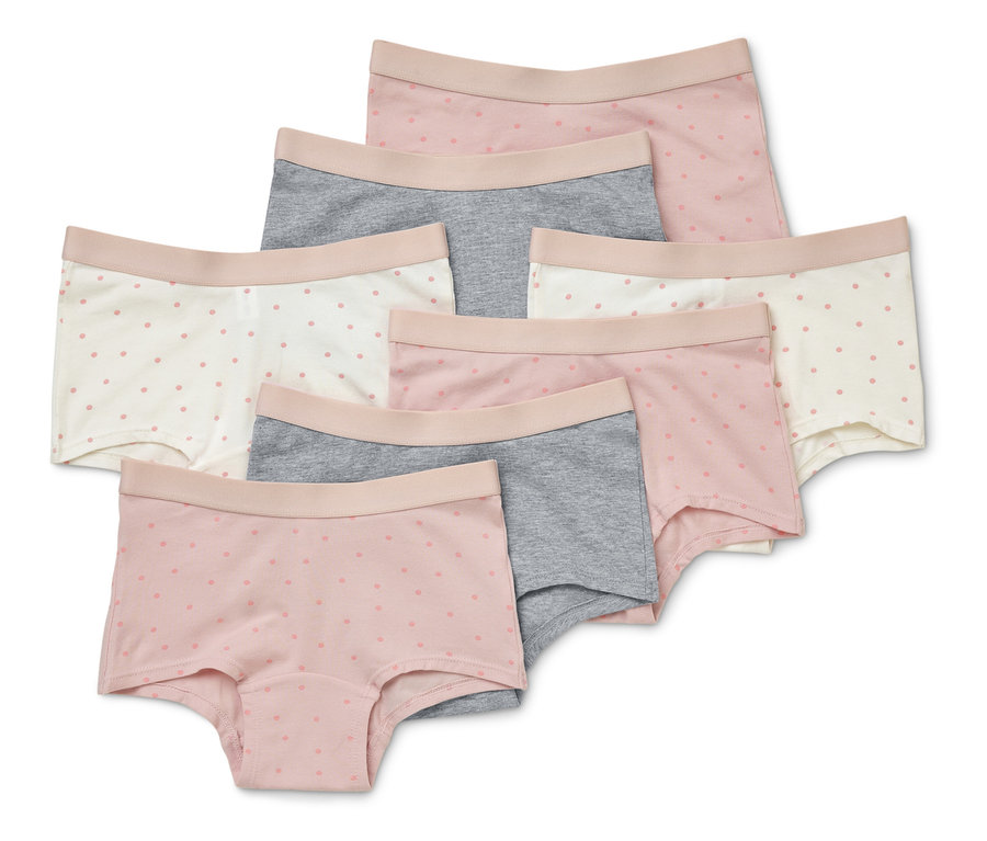 Siedem par krótkich damskich majtek w kolorach różowym, szarym i białym w delikatne kropki ułożonych jeden na drugim.