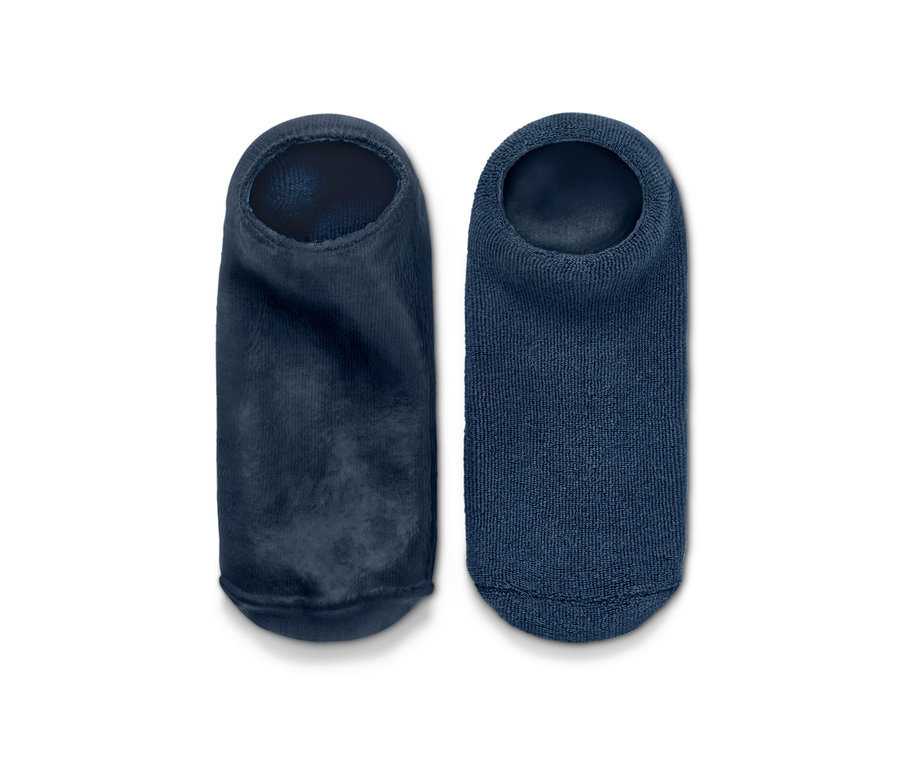 Dwie niebieskie skarpetki pielęgnujące stopy obok siebie.