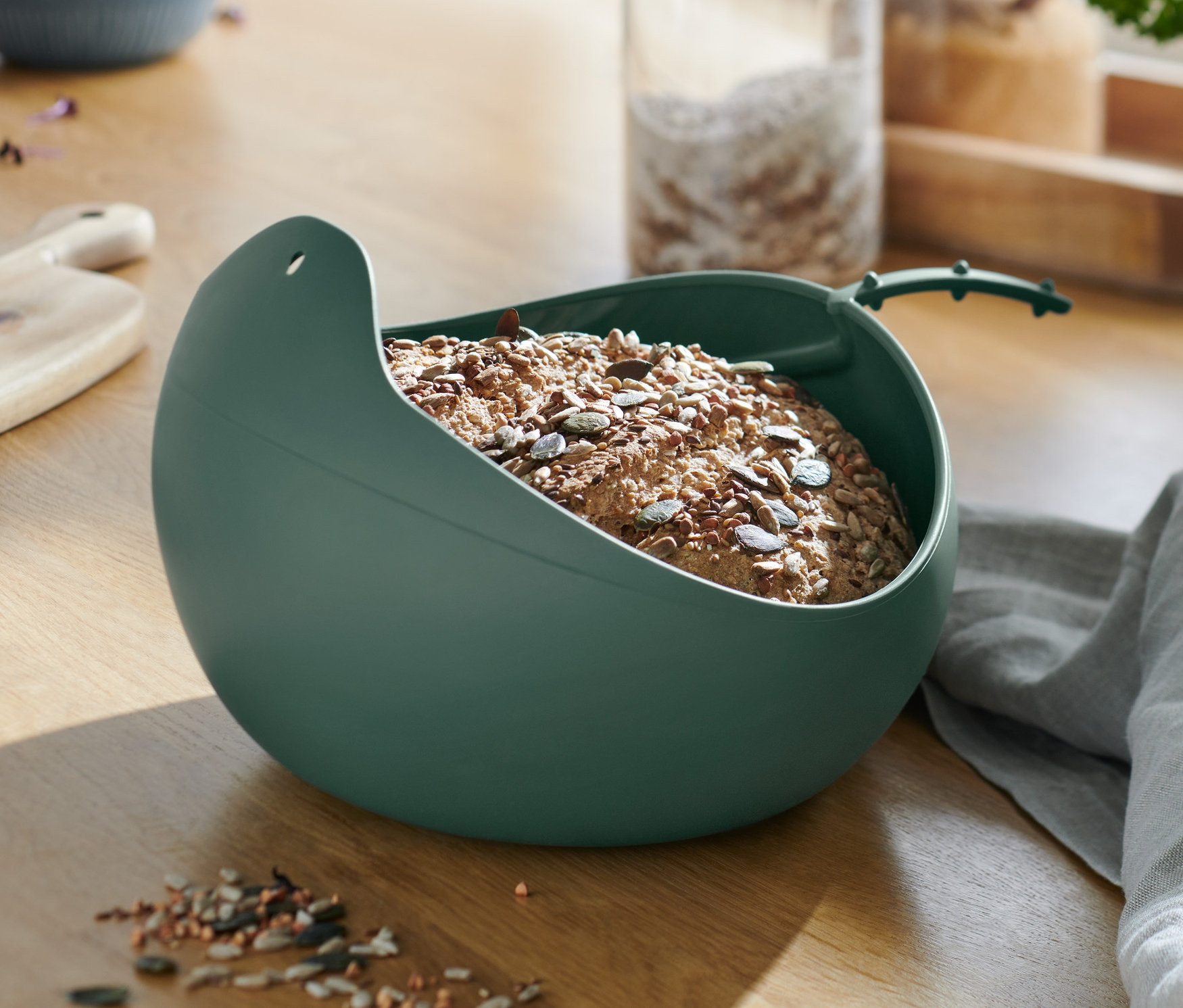 Chleb w misce do pieczenia chleba na drewnianym stole.