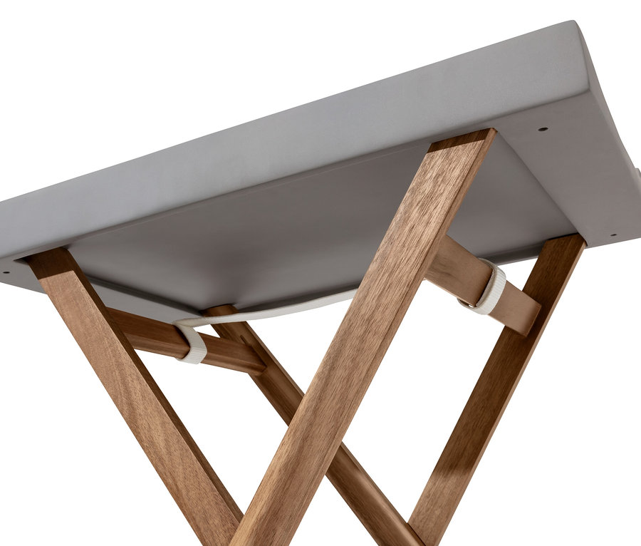 Szczegół szarego stolika z blatem z polimerobetonu i drewnianymi nogami, widok z dołu.