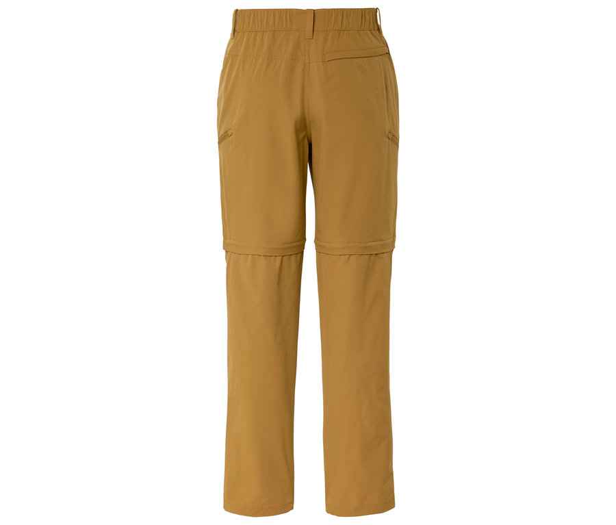 Widok z góry na złożone, ochrowe spodnie trekkingowe z odpinanymi nogawkami.