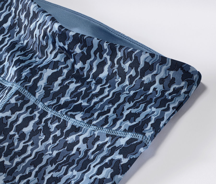 Zbliżenie na dwustronne legginsy sportowe w kolorze niebiesko-jasnoniebieskim.