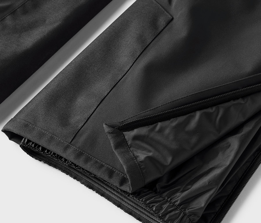 Szczegół czarnych spodni z rozpiętym zamkiem błyskawicznym.