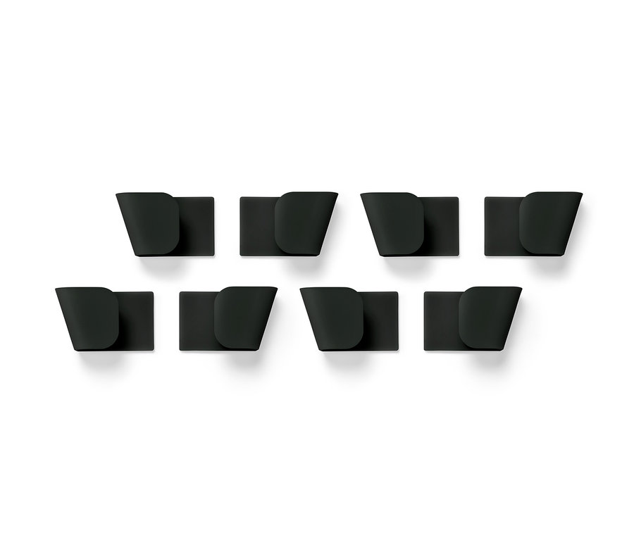 Osiem czarnych uchwytów ściennych na pokrywki, 4 sztuki, ułożonych w dwóch rzędach na białym tle.