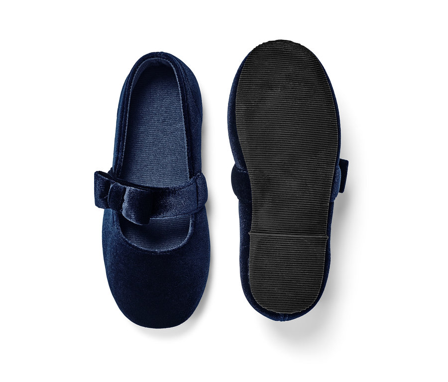 Granatowe aksamitne baleriny. Jeden but leży podeszwą do góry.