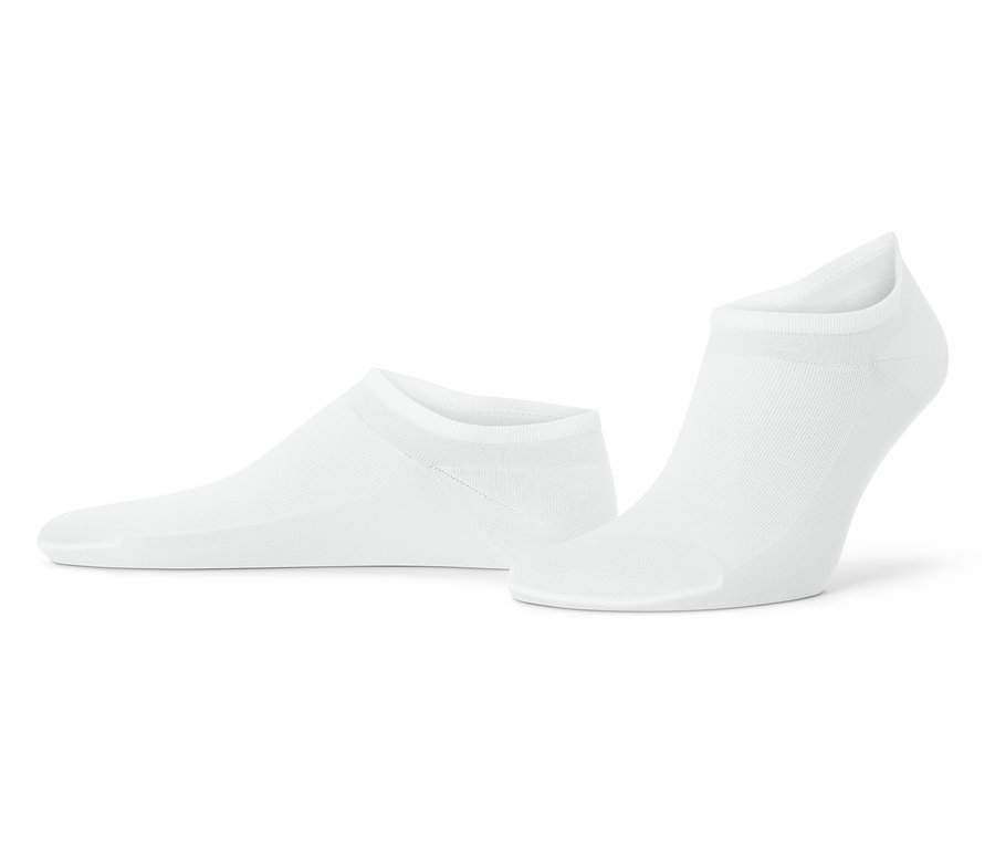 Dwie białe skarpetki leżą na białym tle.