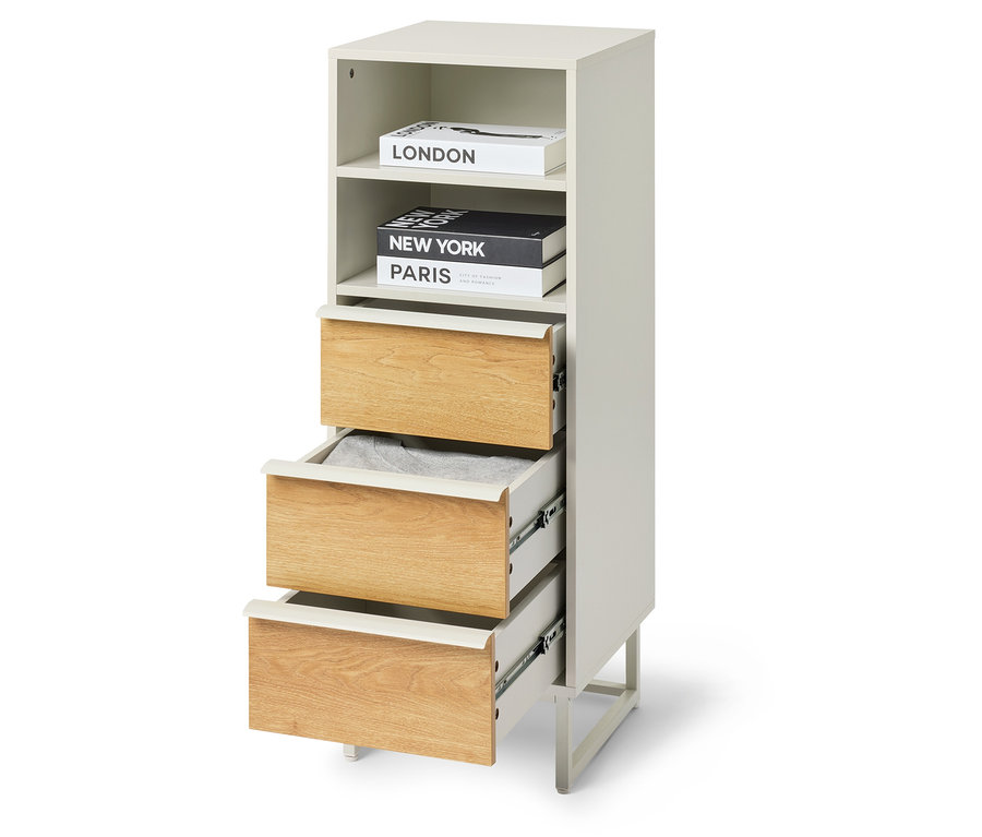 Komoda „LEEG” z 3 szufladami, z których jedna jest częściowo otwarta, a na górze leżą książki.