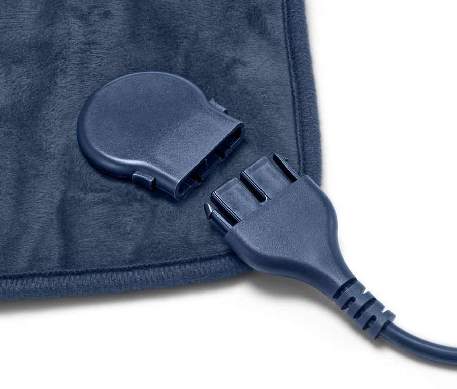 Zbliżenie na małą poduszkę elektryczną z odłączonym kablem.