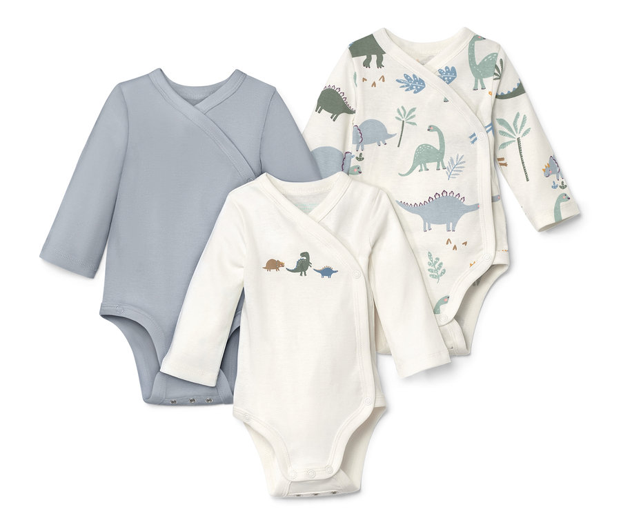 Trzy body z długim rękawem: jedno niebieskie, jedno z motywem dinozaura, jedno we wzory dinozaurów i roślin.