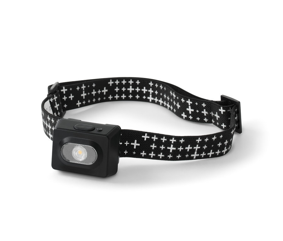 Czarna latarka czołowa z białym wzorem krzyżyków na pasku.