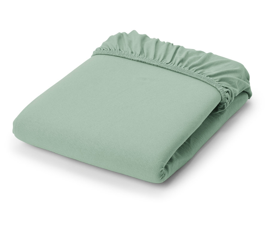 Złożone jasnozielone prześcieradło jersey.