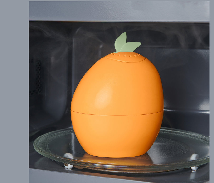 Czyścik do mikrofalówki stoi na szklanym talerzu wewnątrz mikrofalówki.