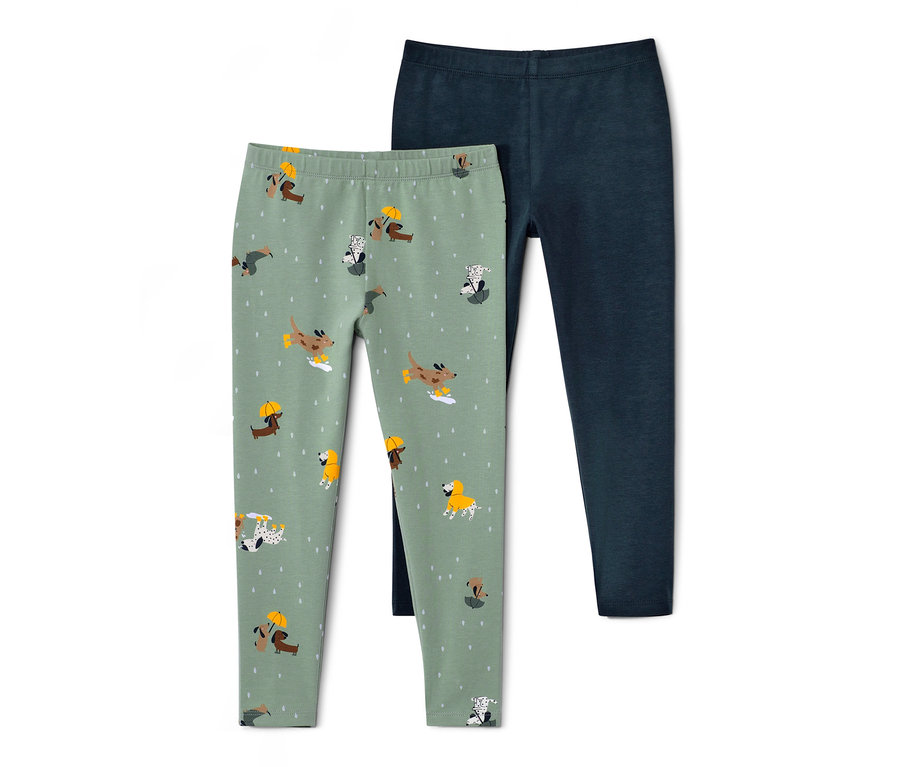 Dwie pary legginsów dziecięcych: jedna jasnozielona z nadrukiem psów, druga ciemnoniebieska.