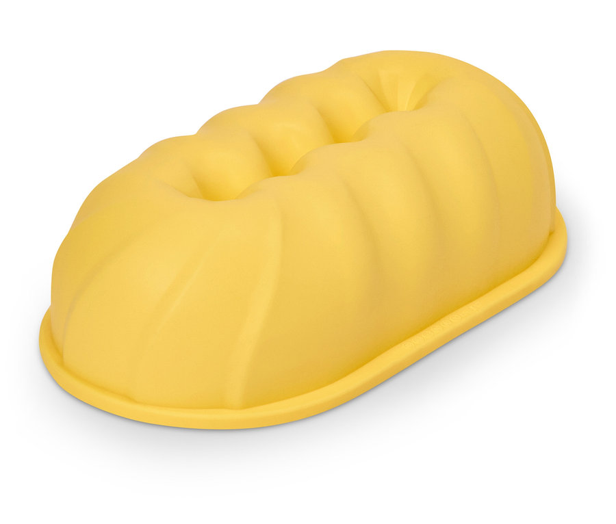 Żółta, podłużna forma do ciasta z żebrowaną górą.