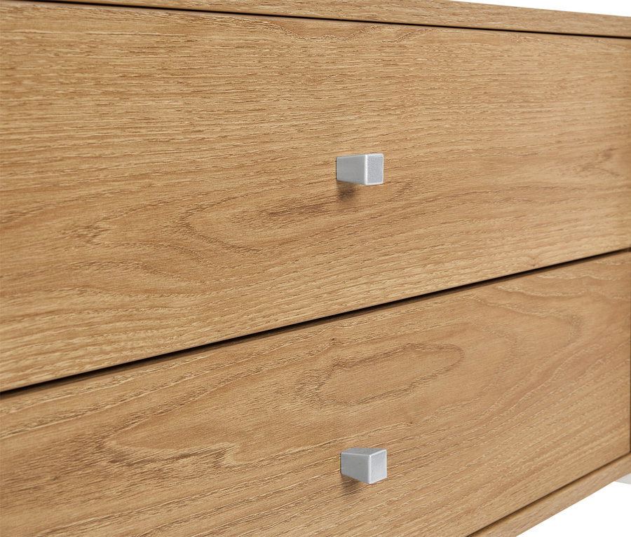 Zbliżenie drewnianej szafki z dwiema szufladami i srebrnymi uchwytami.