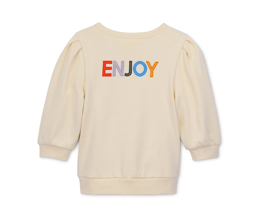 Kremowa bluza z rękawami o długości 3/4 z napisem "ENJOY" w kolorach tęczy.