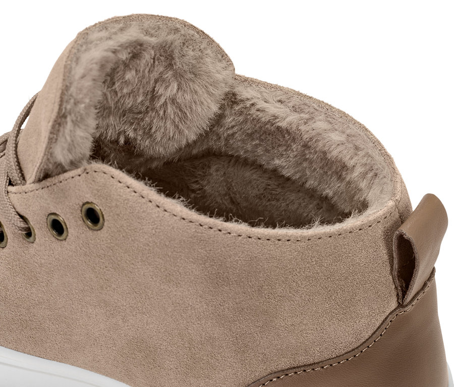 Zbliżenie na but typu sneakers ze skóry welurowej z wyściółką.