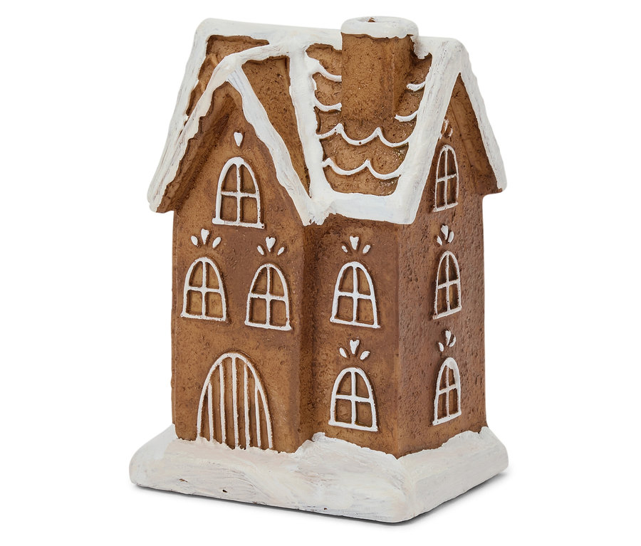 Szczegółowe ujęcie brązowego piernikowego domku z białą lukrową polewą na oknach i dachu.