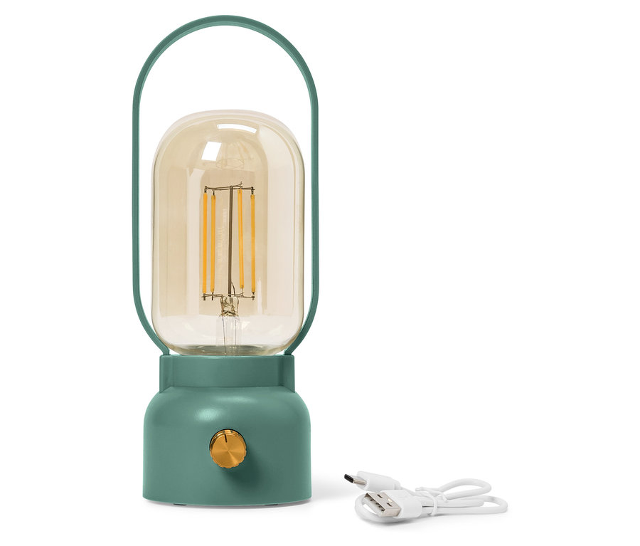 Zielona lampa z żółtą szklaną bańką stoi obok białego kabla USB.