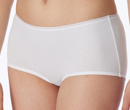 Kobieta ma na sobie białe szorty z bawełną ekologiczną SCHIESSER.