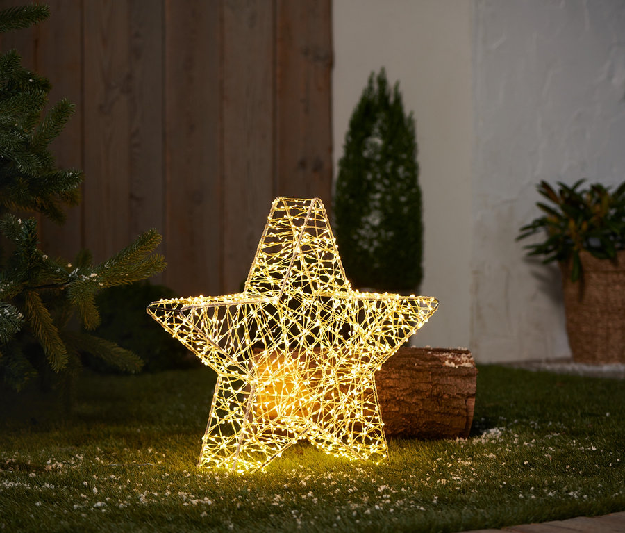 Świecąca gwiazda ogrodowa 3D LED, stojąca, CH, na trawniku.