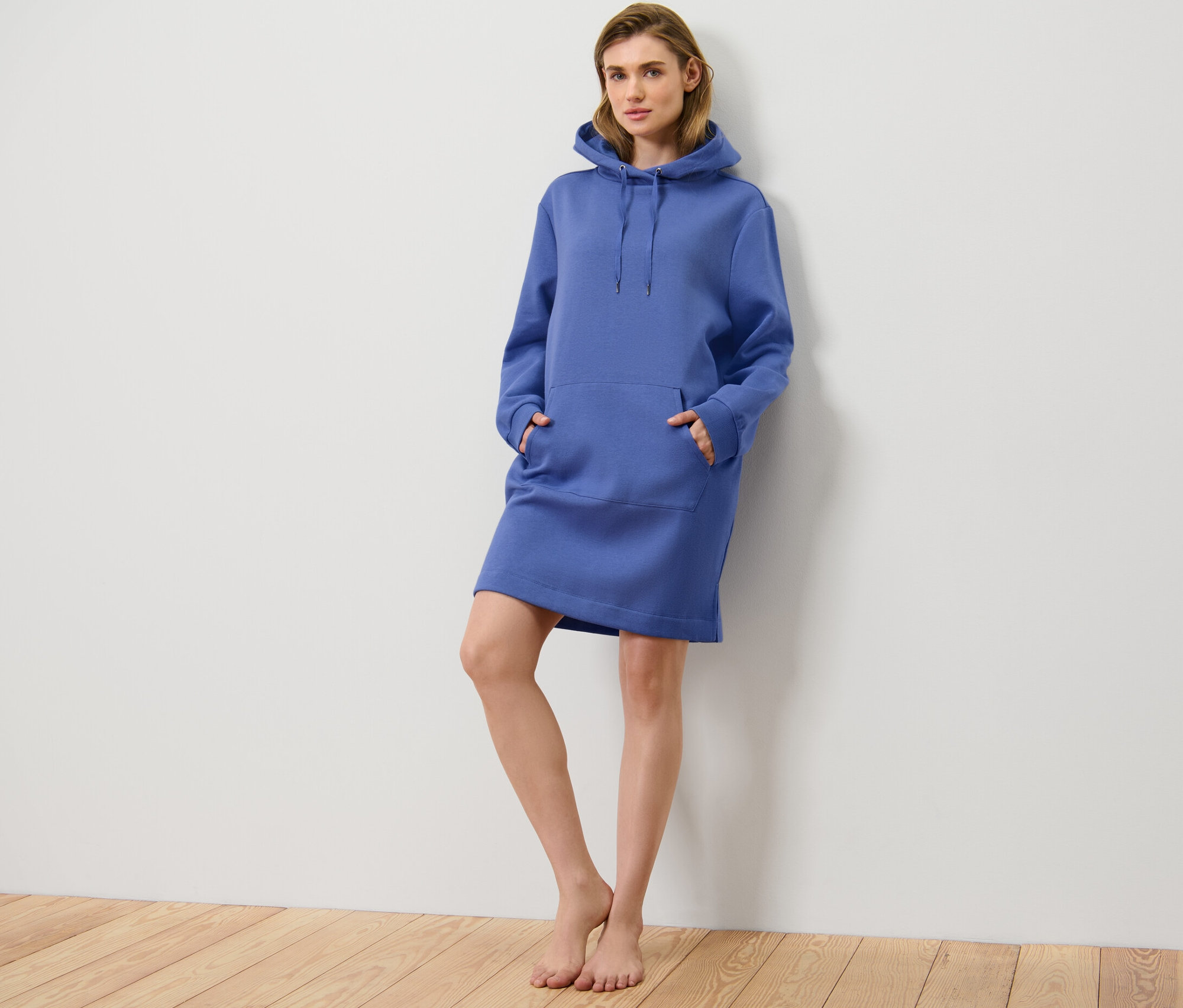 Kobieta pozuje w niebieskiej sukience rekreacyjnej.