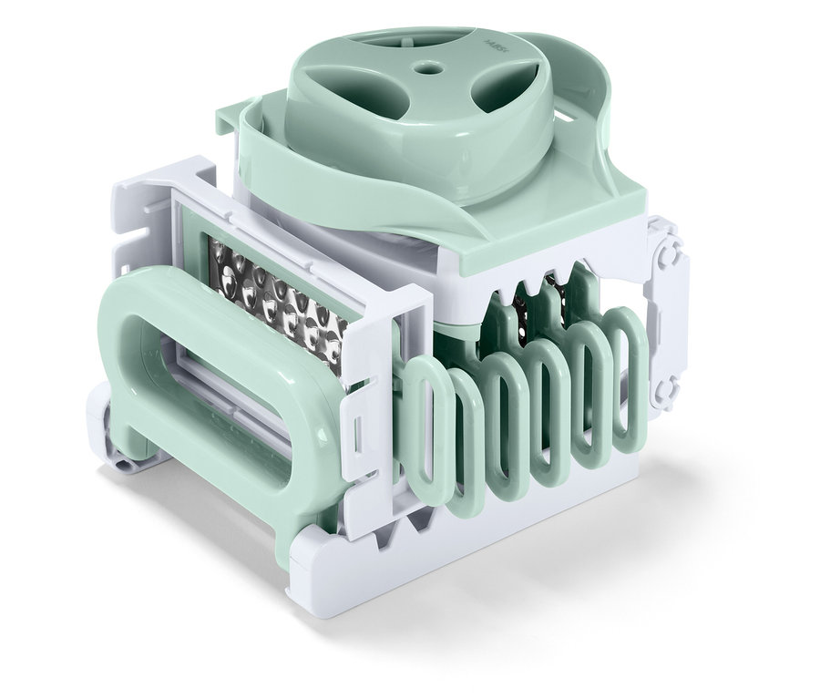 Szczegółowy widok krajalnicy do warzyw w kolorze pastelowej zieleni i bieli.