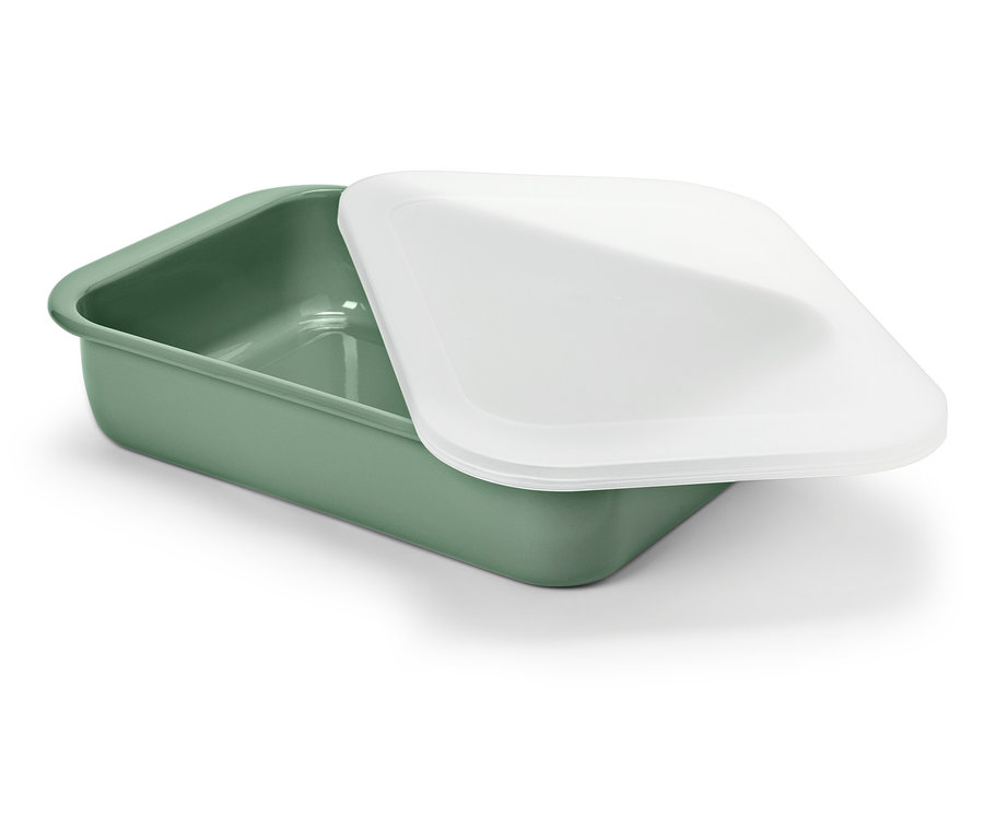 Zielone naczynie z białą pokrywką leży na białym tle.