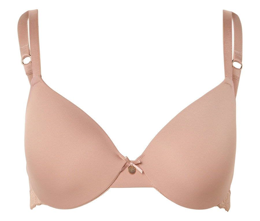 Beżowy biustonosz z regulowanymi ramiączkami, kokardką i małą złotą zawieszką pośrodku.