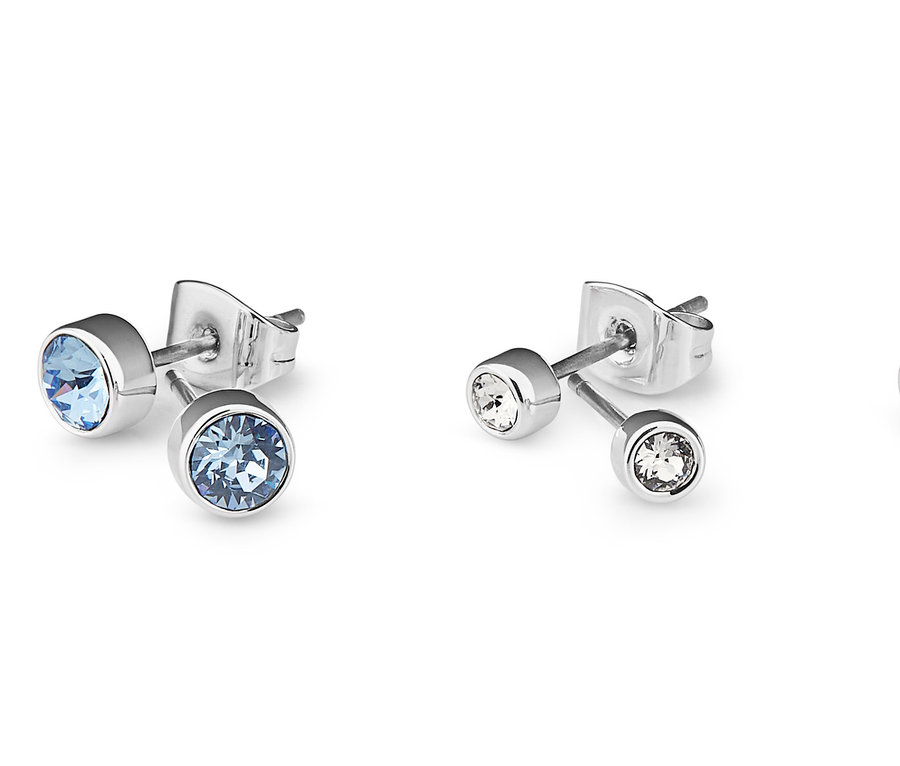 Zbliżenie trzech zestawów kolczyków na sztyft, wysadzanych kryształami marki Swarovski®, na białym tle.