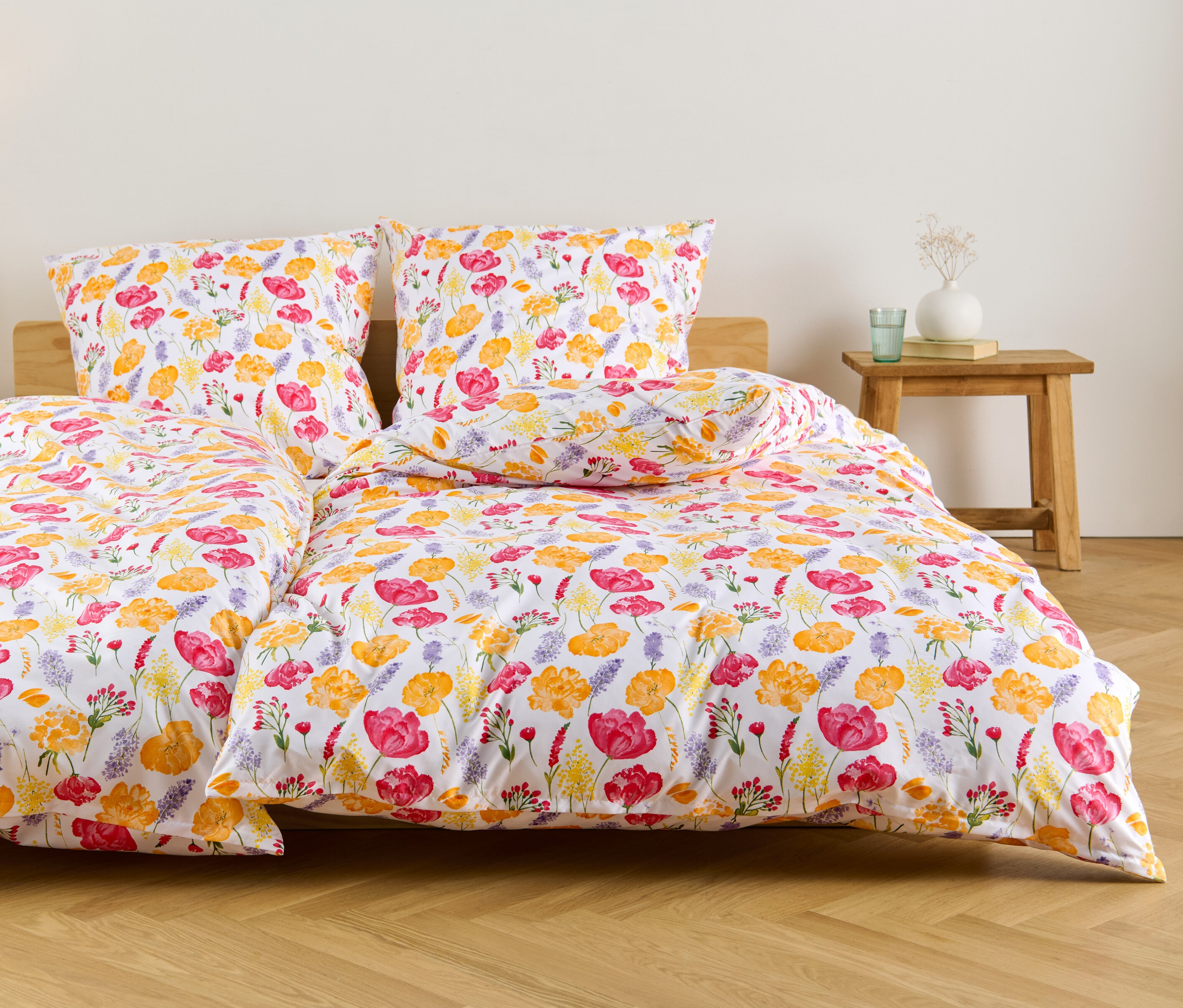 Biała pościel z mikrowłókna w standardowym i niestandardowym rozmiarze we wzory kwiatowe leży na łóżku.