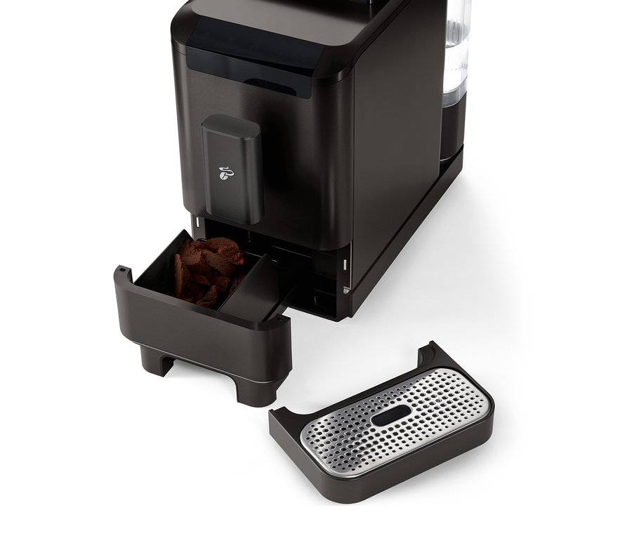 Szczegółowy widok automatycznego ekspresu do kawy »Esperto2 Caffè« w kolorze granite black z wysuniętym pojemnikiem na fusy i tacką ociekową.