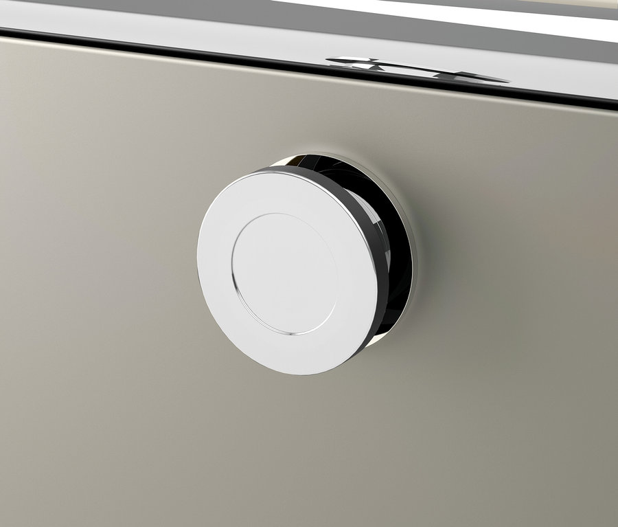 Detal szuflady ze srebrnym, okrągłym uchwytem.