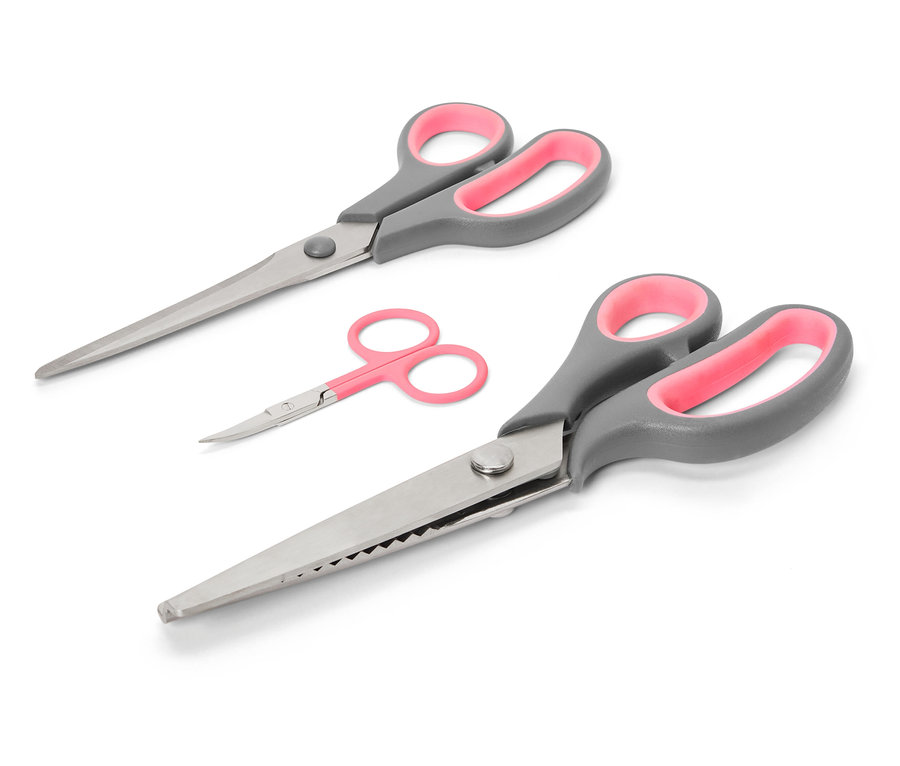 Zestaw nożyczek do tkanin z szarymi uchwytami i różowymi wnętrzami na białym tle.