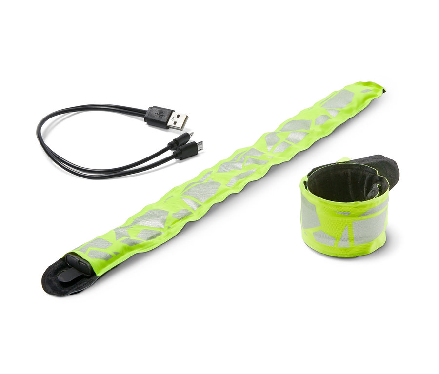 Dwie samozaciskowe opaski LED z kablem USB leżą na białym tle.
