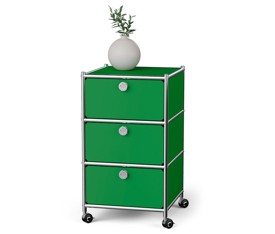 Zielony kontener na kółkach „CN3” z 3 szufladami. Na górze stoi biały wazon.