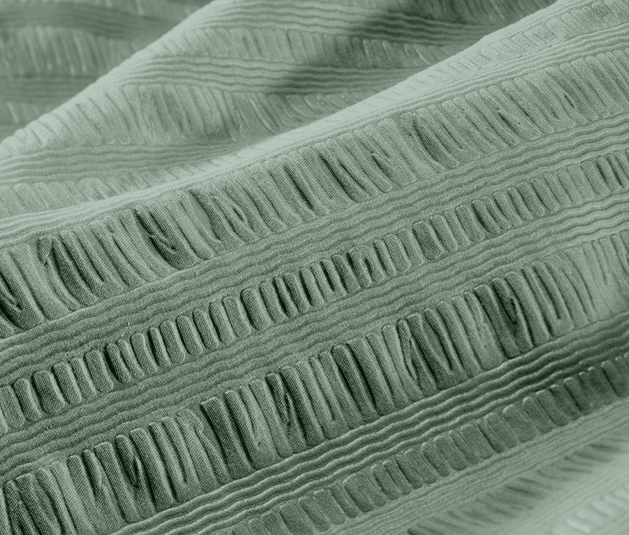 Zbliżenie zielonej pościeli z kory w rozmiarze standardowym i niestandardowym.