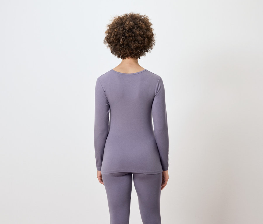 Widok z tyłu kobiety z fryzurą afro w liliowej bieliźnie termicznej.