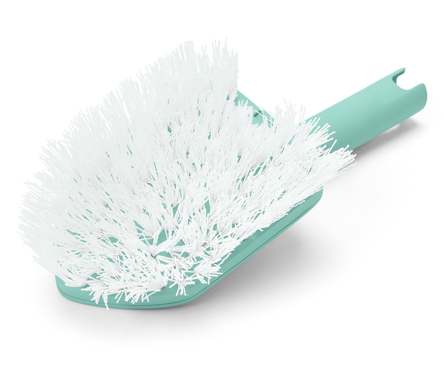 Zbliżenie na białą szczotkę z miętowo-zieloną rączką.