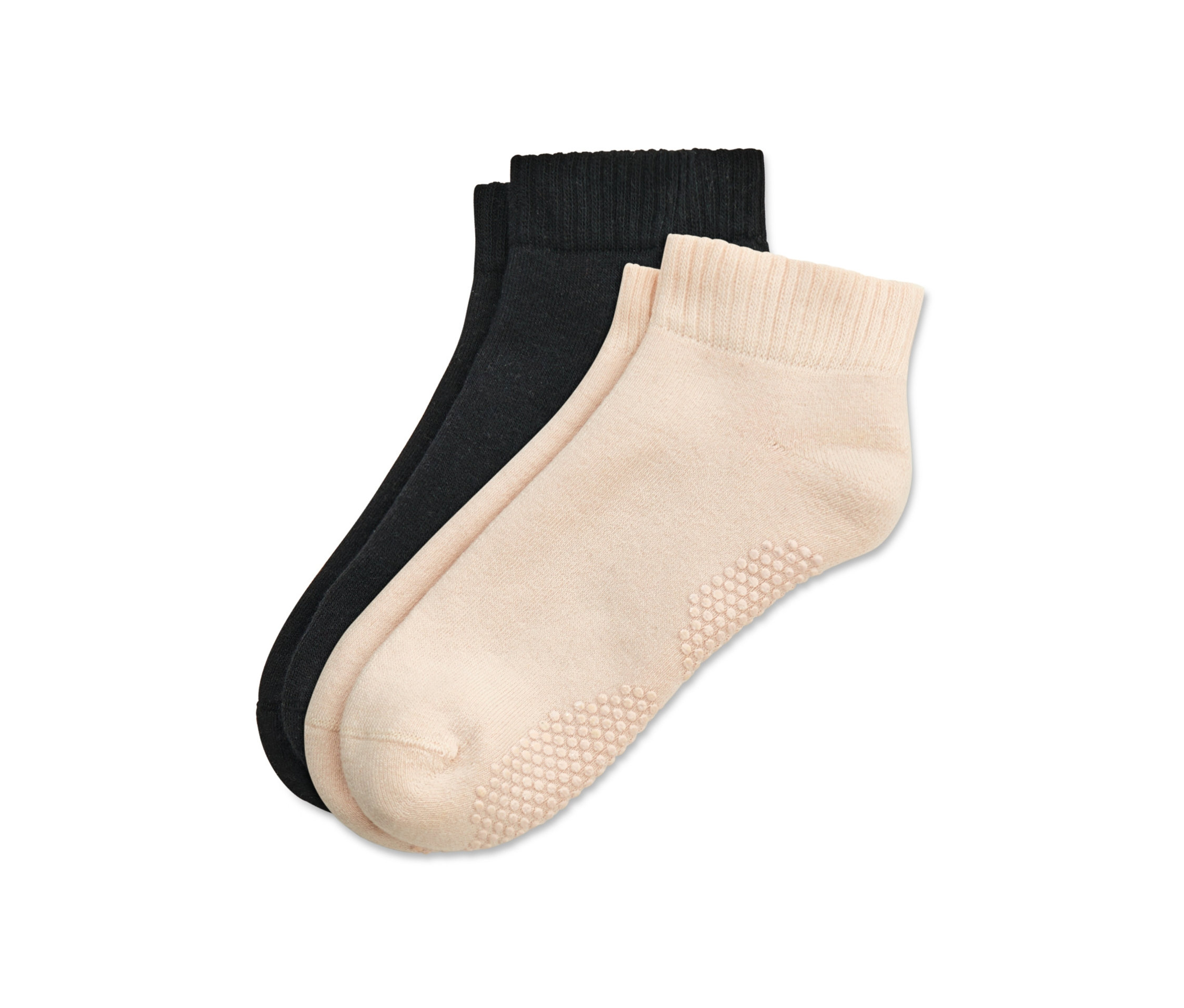 Dwie pary skarpetek do jogi, jedna para czarna i jedna beżowa.